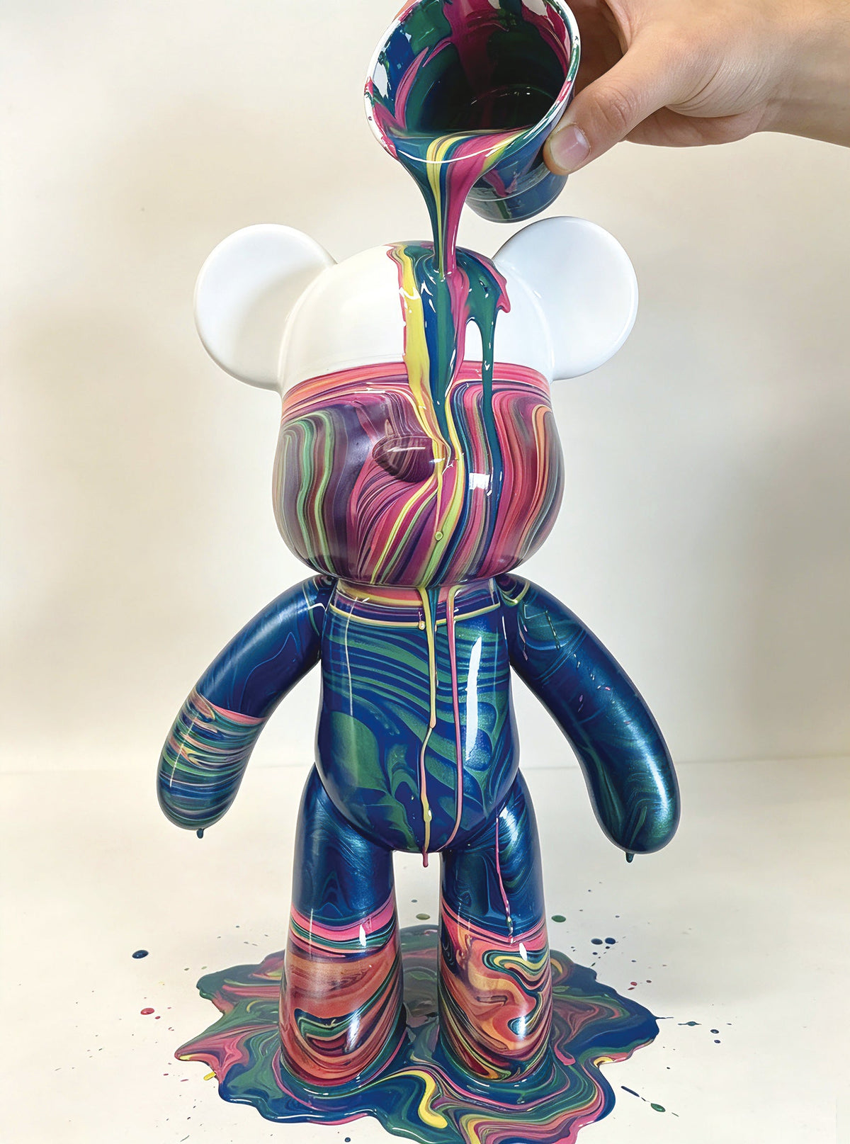 Child painting on ceramic vase with water
