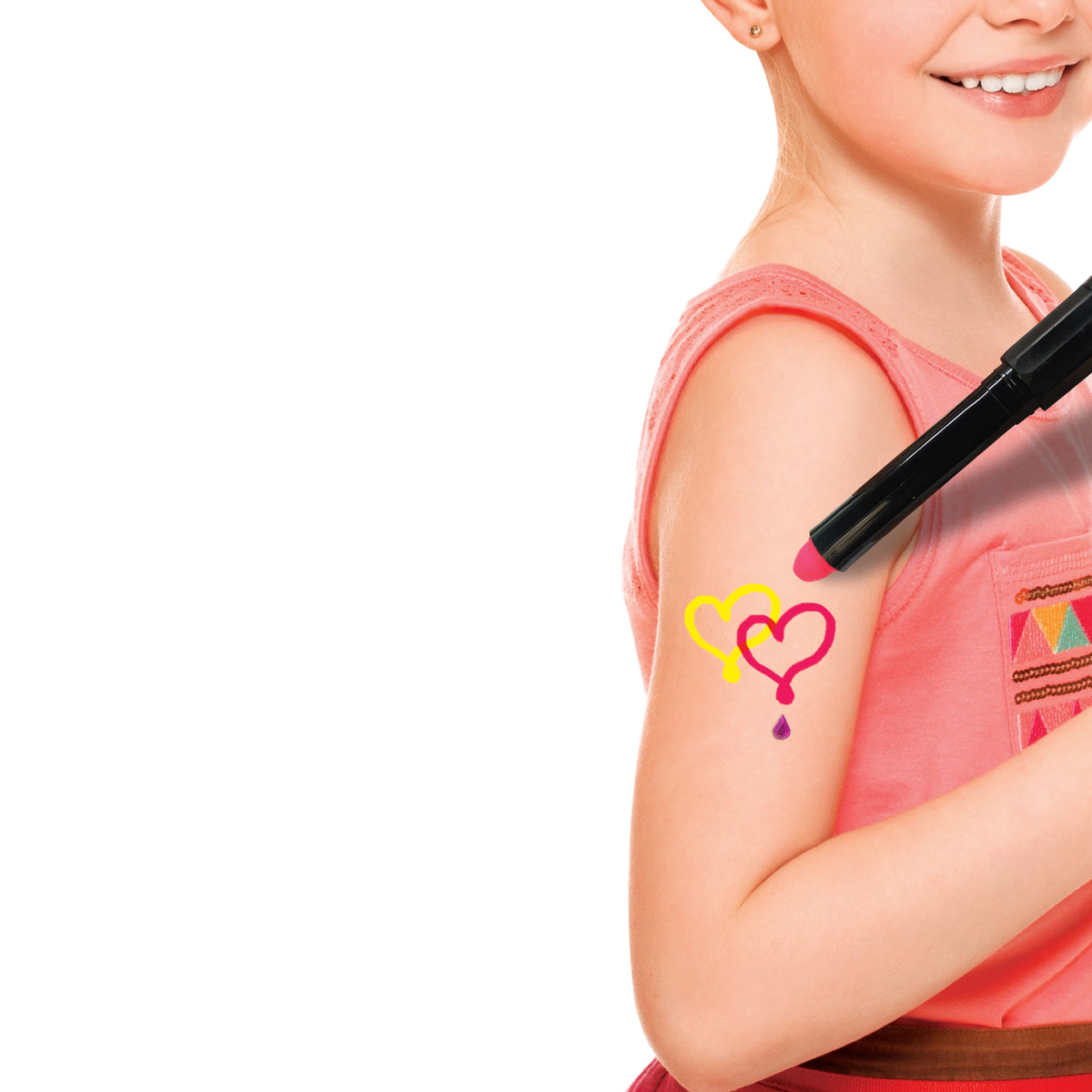 Multiple glowing body art designs created with the craft kit